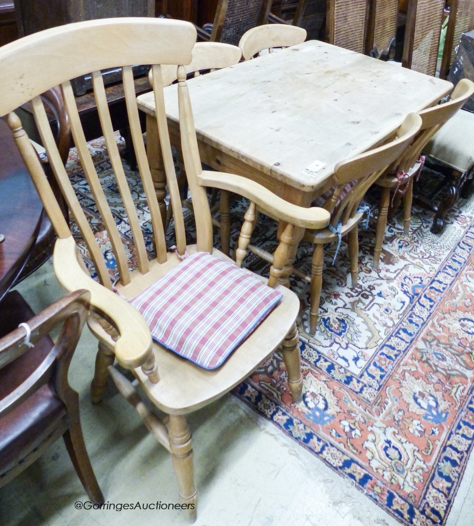 A small Victorian style rectangular pine kitchen table, width 120cm, depth 76cm, height 77cm together with a Windsor beech armchair and two kitchen chairs